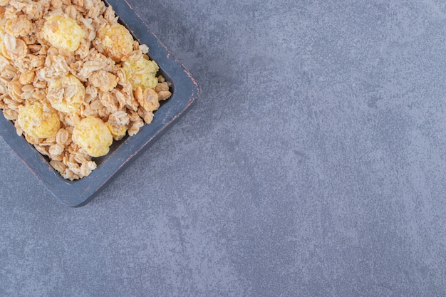 Tasty cornflakes in a board , on the marble background. High quality photo