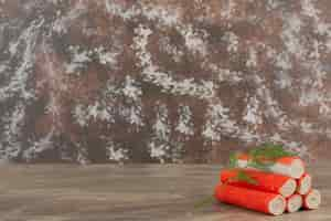 Free photo tasty crab sticks on marble background .