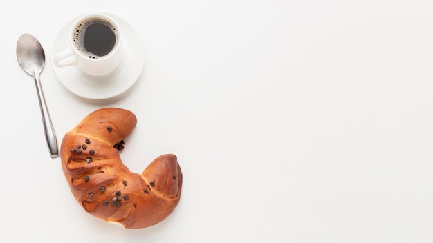 Tasty croissant and coffee copy space