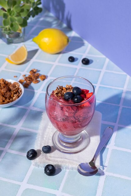 tasty cup of açai dessert with berries