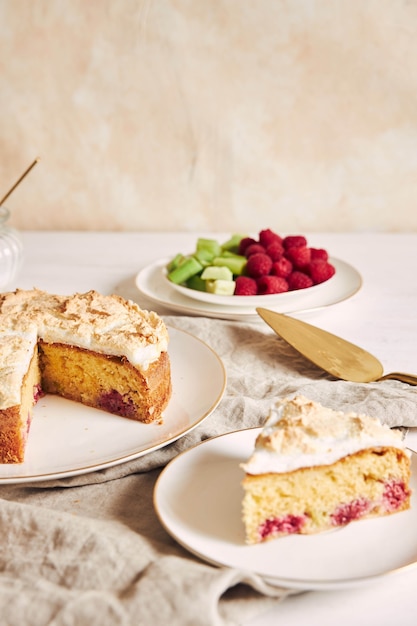 Tasty and delicious cake with baiser and  raspberries on a plate