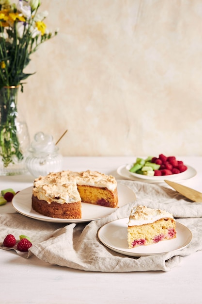Tasty and delicious cake with baiser and  raspberries on a plate