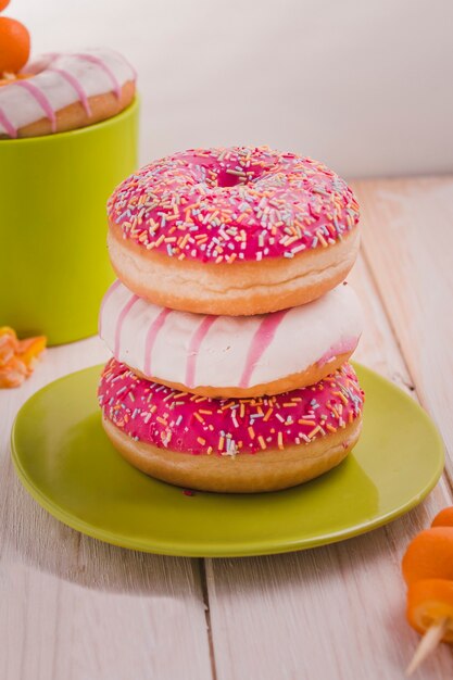 Tasty donuts with colorful sprinkles