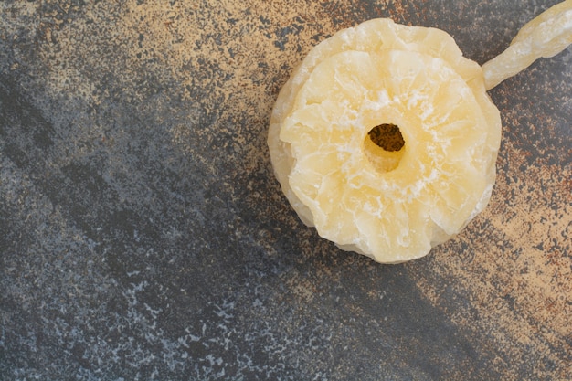 Tasty dried pineapples on marble background. High quality photo