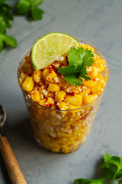 tasty esquites with spices in cups high angle
