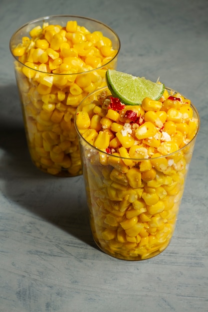 Tasty esquites with spices in cups