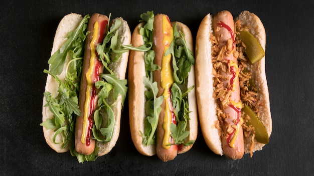 Tasty fast-food hot dog flat lay
