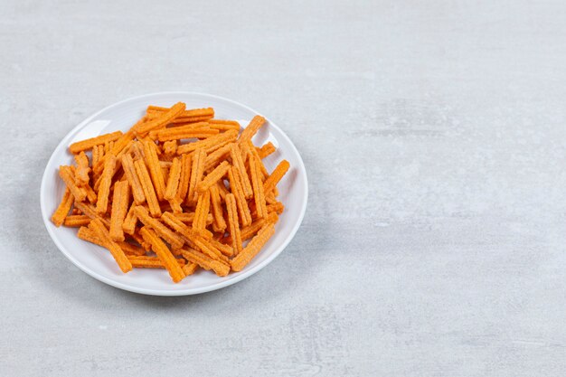 Tasty french fries on white plate.