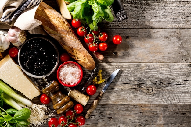 Tasty fresh appetizing italian food ingredients for cooking on old rustic wooden background. 