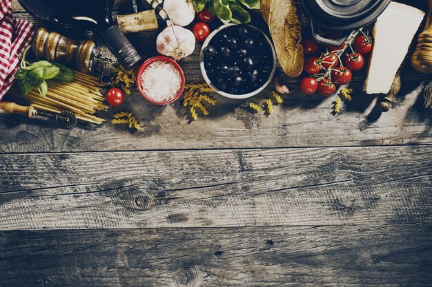 Tasty fresh appetizing italian food ingredients on old rustic wooden background. Ready to cook. Home Italian Healthy Food Cooking Concept. Toning.