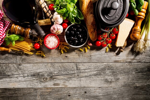 Tasty fresh appetizing italian food ingredients on old rustic wooden background. Ready to cook. Home Italian Healthy Food Cooking Concept. 