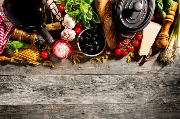 Tasty fresh appetizing italian food ingredients on old rustic wooden background. Ready to cook. Home Italian Healthy Food Cooking Concept. 