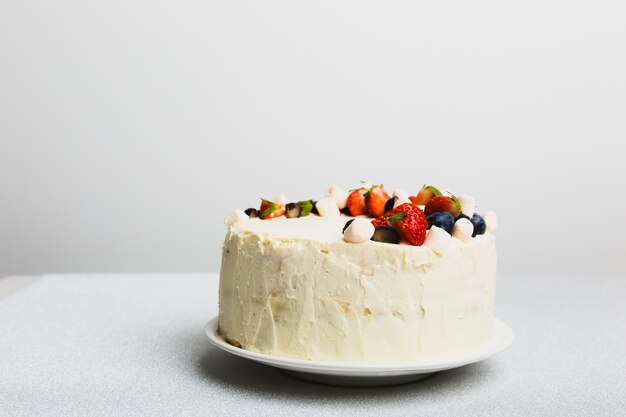 Tasty fresh cake with berries on dish