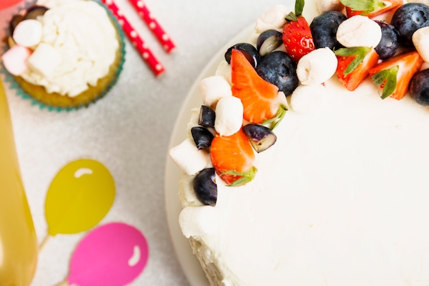 Tasty fresh cake with berries on table