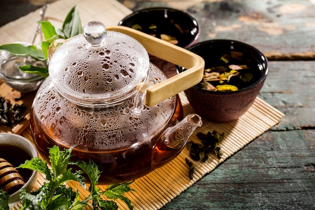 Tasty Fresh Green Tea in Glass Teapot Ceremony on Old Rustic Table 