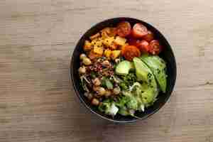 Free photo tasty fresh poke bowl with avocado quinoa and vegetables top view