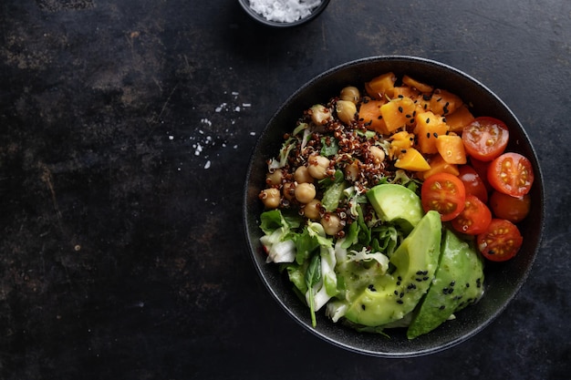 Tasty fresh poke bowl with avocado quinoa and vegetables Top View