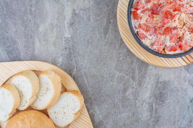 Tasty fried eggs with tomato, greens and white bread. High quality photo