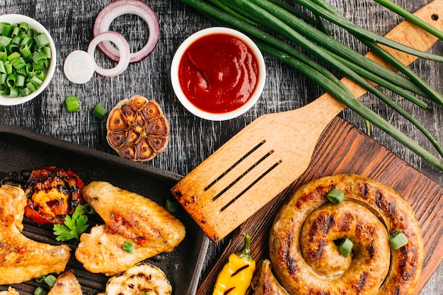 Tasty fried food on grey wooden textured background