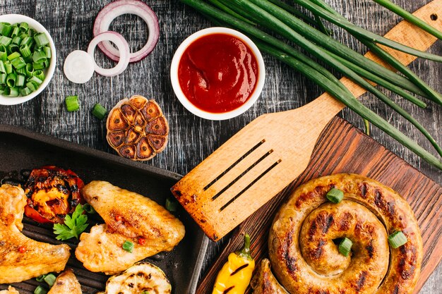 Tasty fried food on grey wooden textured background