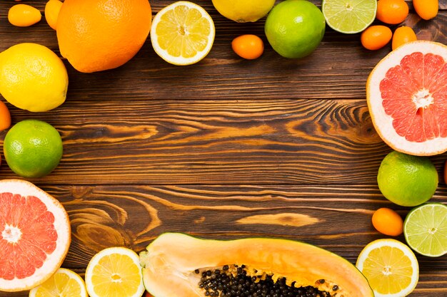 Tasty fruit frame on wooden background