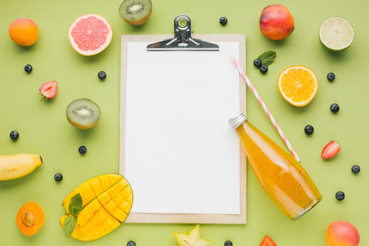 Free Photo tasty fruit and juice frame with clipboard