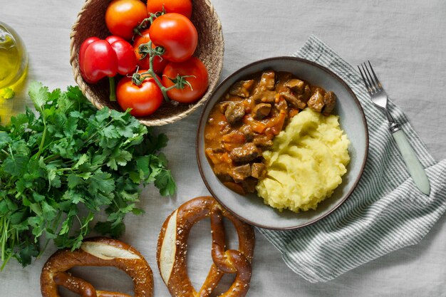 Tasty goulash and mashed potatoes flat lay