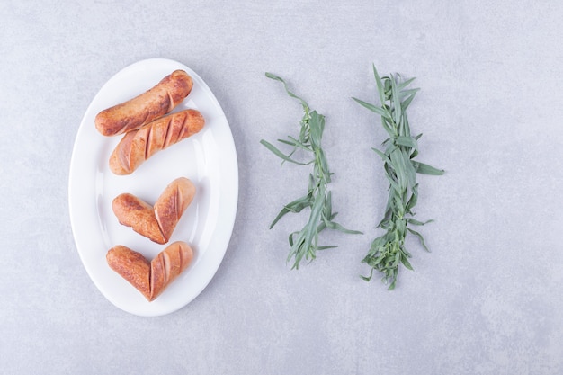 Tasty grilled sausages on white plate. 