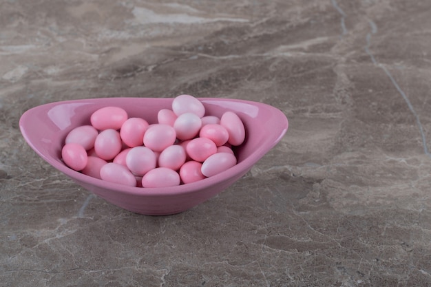 Free photo tasty gumballs in the bowl on the marble surface