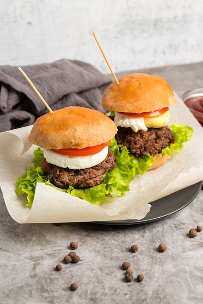 Tasty hamburgers on grey table