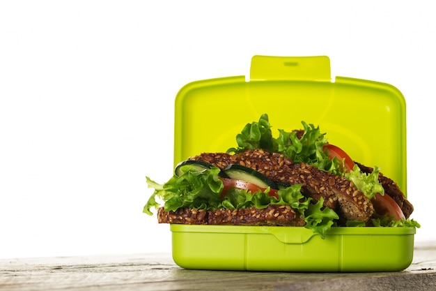 Tasty Healthy Vegetarian Vegan Sandwich in Lunch Box on Wooden Table on White Isolated Background. Horizontal. Copy Space.