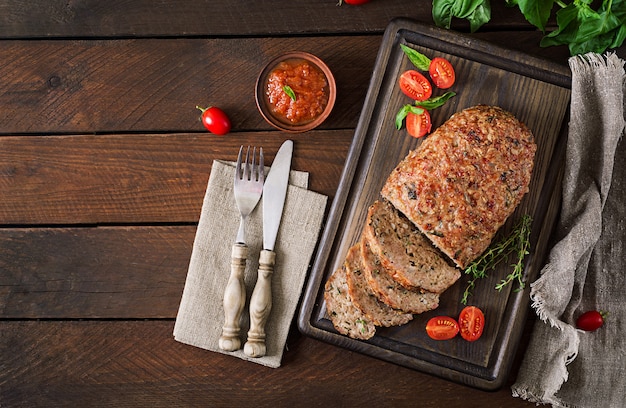 Tasty homemade ground  baked turkey meatloaf on wooden table.
