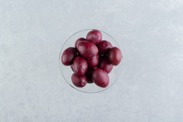 Tasty homemade pickled plums in glass.  