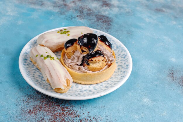 Tasty homemade pistachio eclairs with white chocolate.