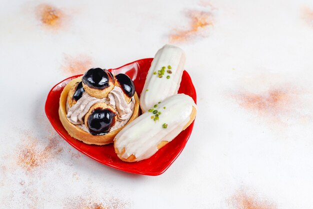 Tasty homemade pistachio eclairs with white chocolate.