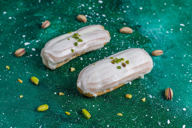 Tasty homemade pistachio eclairs with white chocolate.