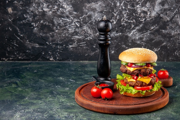 Tasty homemade sandwich tomatoes pepper on cutting board on dark color surface