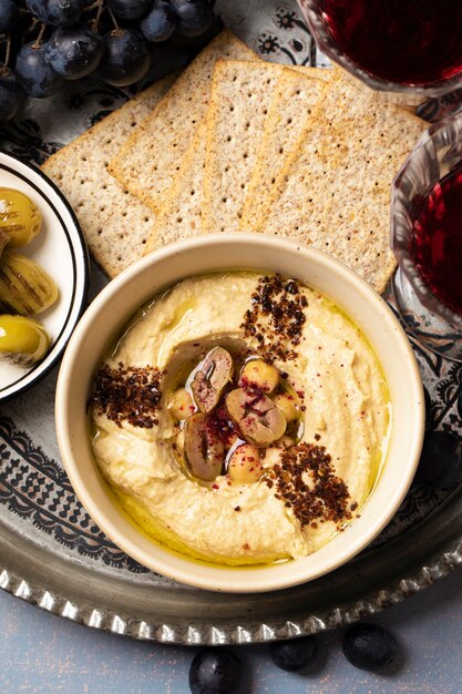 Tasty hummus on plate still life top view