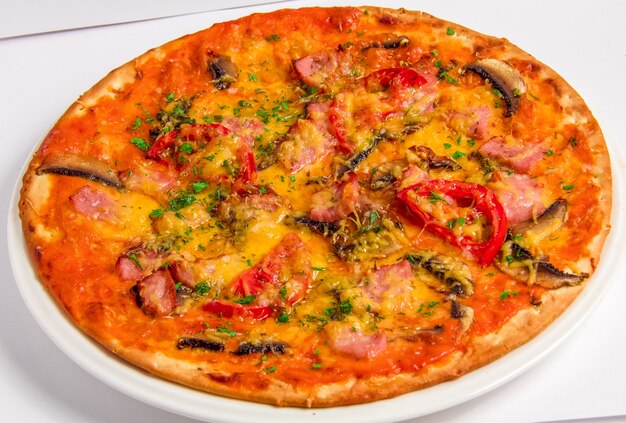 Tasty italian Pizza with bacon and tomatoes