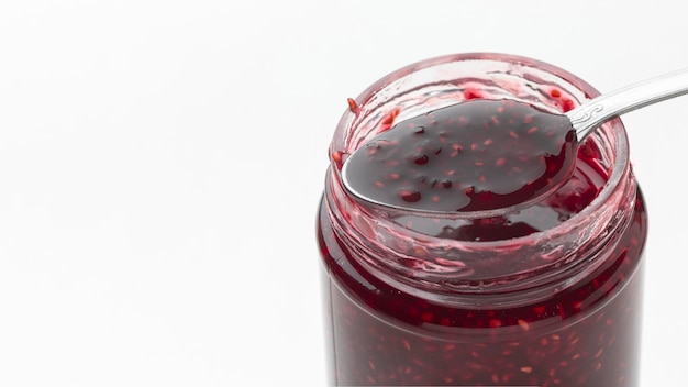 Tasty jam in transparent jar