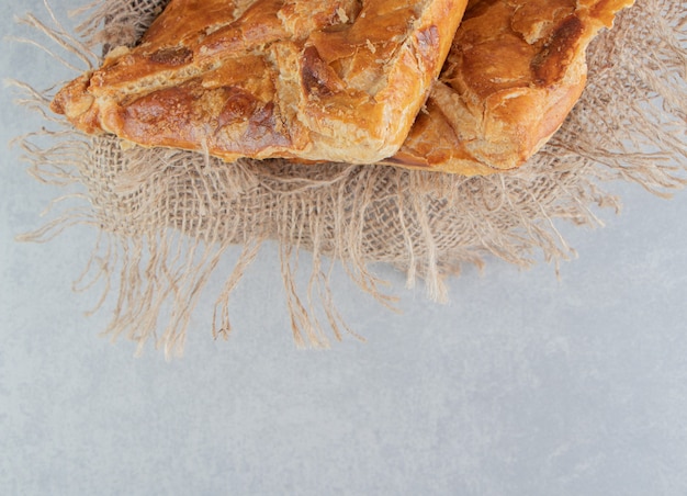 Tasty khachapuri pastries in wooden box.