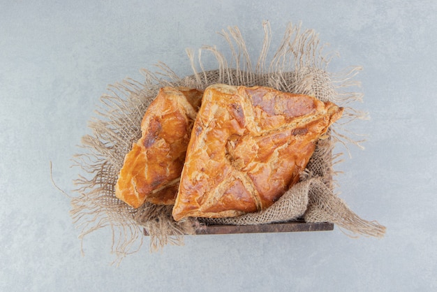 Tasty khachapuri pastries in wooden box. 