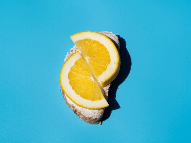 Tasty lemon slices on bread top view