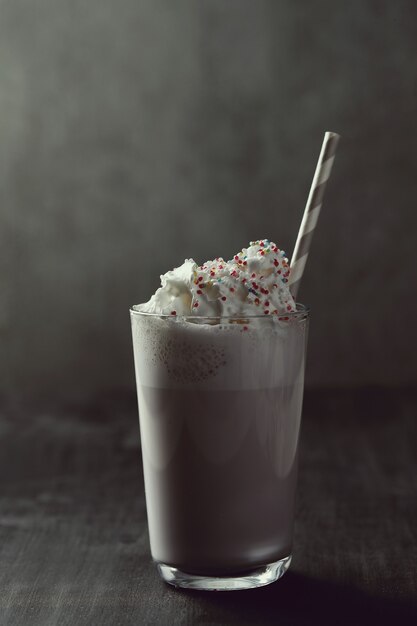 Tasty milkshake drink with straw