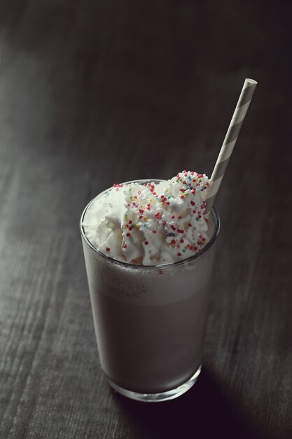 Tasty milkshake drink with straw