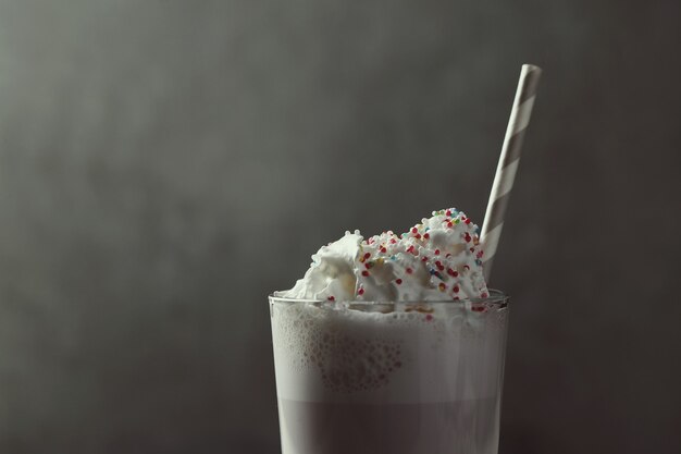 Tasty milkshake drink with straw