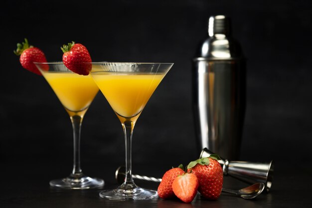 Tasty mimosa cocktail glasses with strawberries