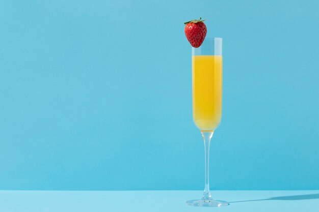 Tasty mimosa cocktail with blue background
