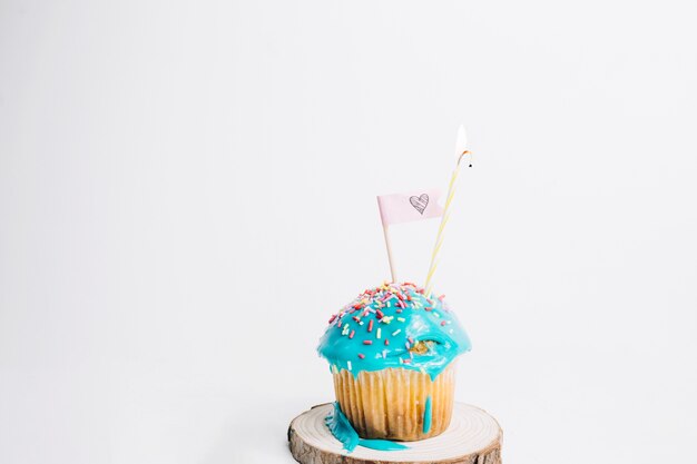 Tasty muffin with flag and candle