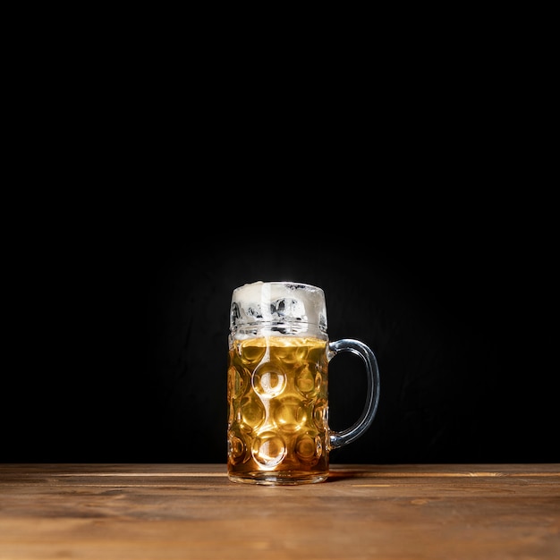 Tasty mug of bavarian beer with black background